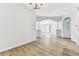 Spacious living room featuring wood floors, neutral paint, and an arched entryway at 31434 Shaker Cir, Wesley Chapel, FL 33543