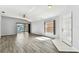 Spacious living room with wood flooring and a sliding glass door to the patio at 31434 Shaker Cir, Wesley Chapel, FL 33543