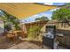 Cozy backyard featuring a shade sail, patio, grill, and dining set, ideal for outdoor entertaining at 3600 46Th N St, St Petersburg, FL 33713