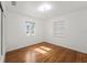 Bright bedroom features hardwood floors, built-in shelving, and natural light from the window at 3600 46Th N St, St Petersburg, FL 33713