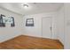 A simple bedroom with wood-look floors and two windows for natural light at 3600 46Th N St, St Petersburg, FL 33713