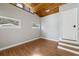 Cozy bedroom showcasing wood-look floors, vaulted ceiling, and natural light at 3600 46Th N St, St Petersburg, FL 33713