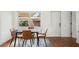 Modern dining room featuring a black table, stylish chairs, and a large window at 3600 46Th N St, St Petersburg, FL 33713