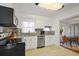 Modern kitchen with white cabinets, stainless steel appliances, and grey backsplash at 3600 46Th N St, St Petersburg, FL 33713
