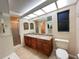 Bathroom features a double vanity, granite countertop, and walk-in shower at 3907 Applegate Cir, Brandon, FL 33511
