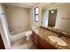 Well-lit bathroom with a granite vanity, tiled walls, and shower-tub combination at 3907 Applegate Cir, Brandon, FL 33511