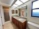 Bathroom featuring granite countertops, double sinks, shower, and natural light at 3907 Applegate Cir, Brandon, FL 33511