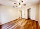 Bright bedroom featuring wood floors, ceiling fan, and closet for ample storage at 3907 Applegate Cir, Brandon, FL 33511