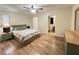 Bedroom with wood-look flooring, ceiling fan, and ensuite bath access at 3907 Applegate Cir, Brandon, FL 33511