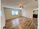 This spacious bedroom features wood floors, a ceiling fan, closet, and a bathroom at 3907 Applegate Cir, Brandon, FL 33511