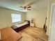 Bedroom with natural light, hardwood floors, a twin bed, and nautical decor at 3907 Applegate Cir, Brandon, FL 33511