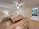 Bedroom with wood floors, ceiling fan, closet, and ensuite bath at 3907 Applegate Cir, Brandon, FL 33511