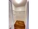 Walk-in closet with shelving and wood floors at 3907 Applegate Cir, Brandon, FL 33511
