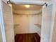 The open, walk-in closet has white shelving, ample storage space, and hardwood floors at 3907 Applegate Cir, Brandon, FL 33511