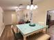 Dining area open to other living spaces and featuring a unique table and view into the kitchen at 3907 Applegate Cir, Brandon, FL 33511
