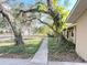 Lush front yard adorned with mature trees and landscaped walkway at 3907 Applegate Cir, Brandon, FL 33511