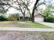 Charming home featuring a lush lawn and mature trees enhancing curb appeal at 3907 Applegate Cir, Brandon, FL 33511