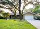 Charming single story home with two car garage surrounded by mature trees and a lush lawn at 3907 Applegate Cir, Brandon, FL 33511