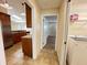 Hallway view into kitchen with stainless appliances and granite countertops and laundry area with washer at 3907 Applegate Cir, Brandon, FL 33511