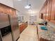 This kitchen features wood cabinets, granite countertops, and stainless steel appliances at 3907 Applegate Cir, Brandon, FL 33511