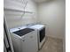 This laundry room includes a washer, dryer, and shelving at 3907 Applegate Cir, Brandon, FL 33511