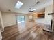 Open-concept living room featuring wood floors and brick fireplace at 3907 Applegate Cir, Brandon, FL 33511