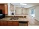 Open-concept living area with a brick fireplace, adjacent to the kitchen and dining area at 3907 Applegate Cir, Brandon, FL 33511