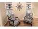 Cozy living room with custom built-in shelving, stylish chairs, and wood flooring throughout at 3907 Applegate Cir, Brandon, FL 33511