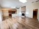 Open-concept living room featuring wood floors and brick fireplace at 3907 Applegate Cir, Brandon, FL 33511