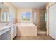 Bright bathroom featuring a large garden tub and a separate glass-enclosed shower at 417 Ventura Dr, Oldsmar, FL 34677
