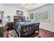 Cozy bedroom featuring hardwood floors, a ceiling fan, and a bright window at 417 Ventura Dr, Oldsmar, FL 34677