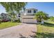 Charming two-story home with a brick driveway, lush lawn, and is situated on a cul-de-sac at 417 Ventura Dr, Oldsmar, FL 34677