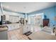 Bright, airy kitchen features a center island, white cabinets, tile floors, and a garden window at 417 Ventura Dr, Oldsmar, FL 34677