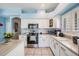 Updated kitchen features stainless appliances, white cabinets, and tile flooring at 417 Ventura Dr, Oldsmar, FL 34677