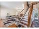 Open-concept living room with hardwood floors and chairlift at 417 Ventura Dr, Oldsmar, FL 34677