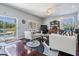 Bright living room boasts wood floors, ceiling fan, and pool view through sliding glass doors at 417 Ventura Dr, Oldsmar, FL 34677