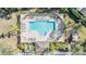 Aerial view of a stunning community pool with lounge chairs and sun shades, perfect for relaxation and enjoyment at 417 Ventura Dr, Oldsmar, FL 34677