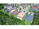 Sprawling suburban neighborhood featuring single-Gathering homes surrounded by lush landscaping and mature trees at 4289 Ortona Ln, Wesley Chapel, FL 33543