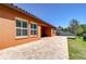 Exterior view of the home showcasing a paved patio and well-maintained lawn, creating an inviting outdoor space at 4289 Ortona Ln, Wesley Chapel, FL 33543