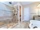 This bathroom features a glass enclosed shower, granite counters, soaking tub, and updated fixtures for spa-like experience at 4289 Ortona Ln, Wesley Chapel, FL 33543