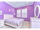 Bedroom with purple walls, white trim, a striped bed, and a window with shutters at 4289 Ortona Ln, Wesley Chapel, FL 33543
