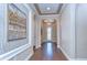 Elegant foyer with hardwood floors, tray ceiling, chandelier, and front door at 4289 Ortona Ln, Wesley Chapel, FL 33543