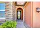 A charming front door with decorative glass, framed by brick and stucco, welcomes you home at 4289 Ortona Ln, Wesley Chapel, FL 33543