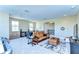 Spacious game room featuring a foosball table, a comfy couch, and a glimpse of the staircase at 4289 Ortona Ln, Wesley Chapel, FL 33543