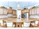 This modern kitchen with wood cabinets, granite counters, and a large center island is the heart of the home at 4289 Ortona Ln, Wesley Chapel, FL 33543