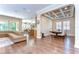Open-concept living space with hardwood floors, a dining area, and kitchen at 4289 Ortona Ln, Wesley Chapel, FL 33543