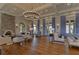 Bright and spacious living room featuring a stone fireplace, hardwood floors, and stylish furnishings at 4289 Ortona Ln, Wesley Chapel, FL 33543