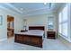 Relax in this spacious main bedroom with tray ceiling, soft carpet, and art niches, offering a tranquil getaway at 4289 Ortona Ln, Wesley Chapel, FL 33543