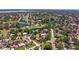 An aerial view of a home nestled among lush trees, adjacent to a scenic golf course and waterways at 4340 Narvarez S Way, St Petersburg, FL 33712