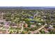 Aerial view of a home near a picturesque golf course, serene lake, and vibrant city skyline at 4340 Narvarez S Way, St Petersburg, FL 33712